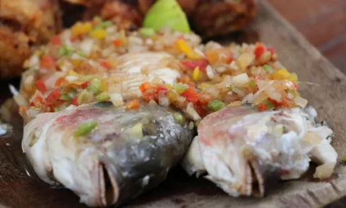 A proximité du Campement Houéfa, vous pourrez déguster des plats traditionnels sénégalais voire gastronomiques. L'image représente un plat garni de carpes grillées et petits légumes.